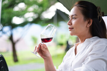 Young woman with glass of red wine