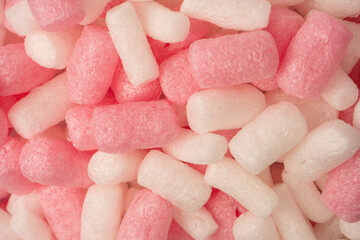 Pink and white box filler as a background. Top view.
