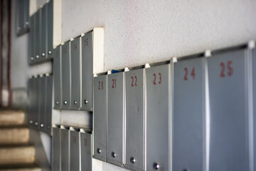 Fototapeta premium Mailboxes display numbers 23, 24, 25, and 26 clearly
