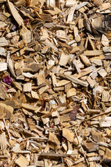 A sizable pile of wood chips is currently sitting on the ground