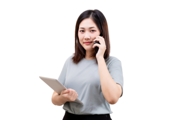 Asian young beautiful woman holding a tablet and talking on a smartphone with a confident expression.