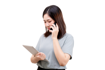 Asian young beautiful woman holds a tablet and talks on a smartphone, appearing focused and engaged in multitasking.