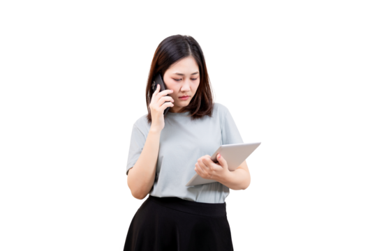 Asian young beautiful woman talks on a smartphone while holding and looking at a tablet.
