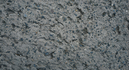 Close Up View Of Rough Textured Grey Concrete Surface With Blue And Orange Granular Pattern