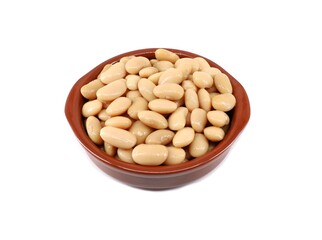 Boiled white Lima beans in a clay serving bowl on white background.