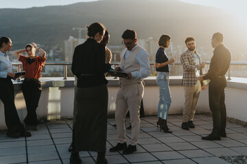 A group of business colleagues brainstorm ideas on a high tower balcony, embracing teamwork and...