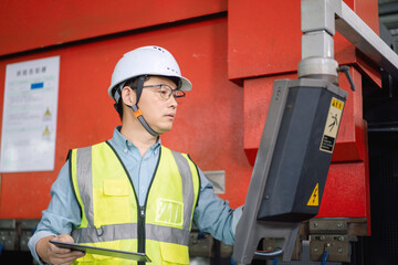 Asian male engineer is operating a bending machine