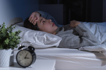 Annoyed, stressed, anxiety asian young woman suffering from insomnia, frustrated awake on bed at...