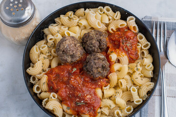 macaroni   top with sauce and meatballs