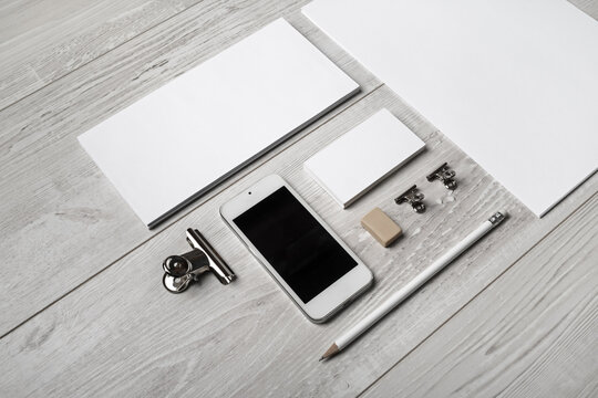 Photo of blank stationery set on light wooden background. Corporate identity mockup. Responsive design template.