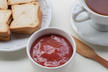 cup of tea and bread with jam