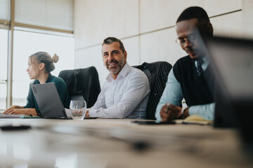 A multicultural group of people engaged in a business meeting, showcasing teamwork and...