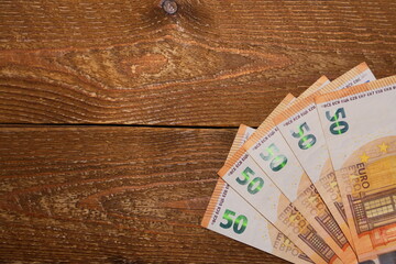 50 euro banknotes on a wooden background