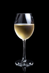 The glass of white wine on a black background