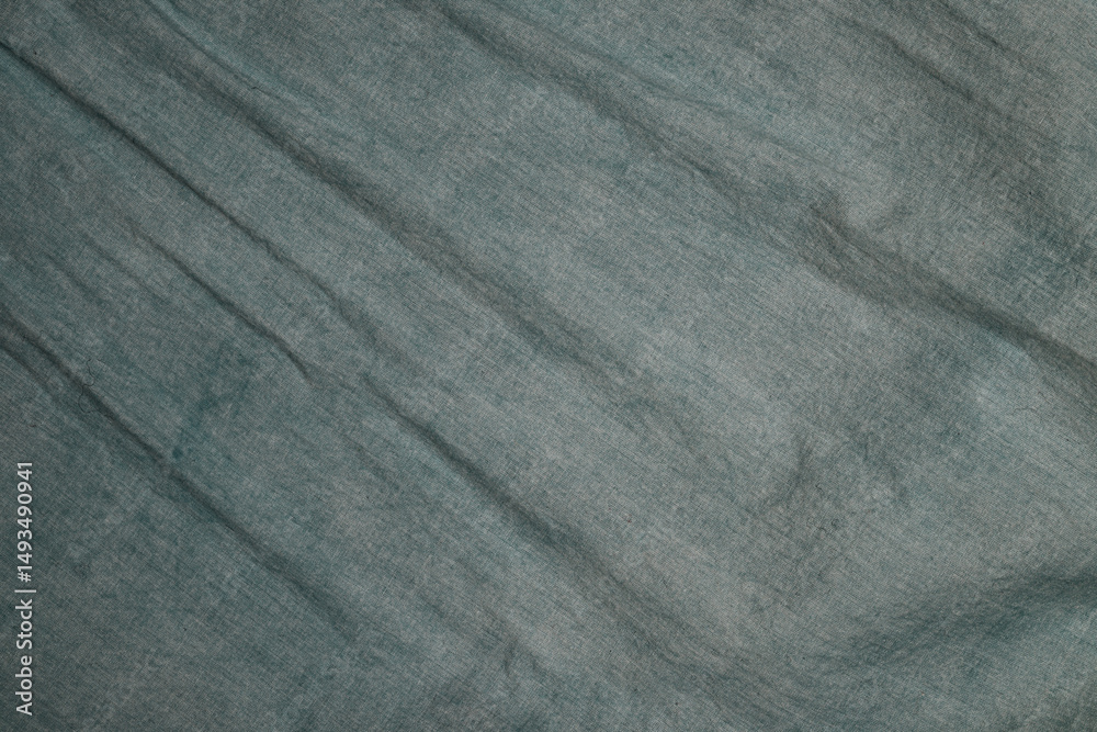 Aufkleber textured fabric surface with subtle folds and creases in a blue-green hue suitable for various artis