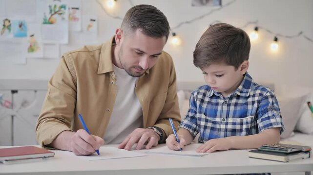 Father and Son Bonding Over Writing at the Table