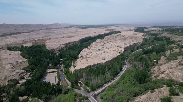 Turpan, China: Aerial drone footage of the ruins of the famous Jiaohe ancient city that lies on a plateau surrounded by steep cliff in Turpan in Xinjiang, China. Shot with an orbit motion