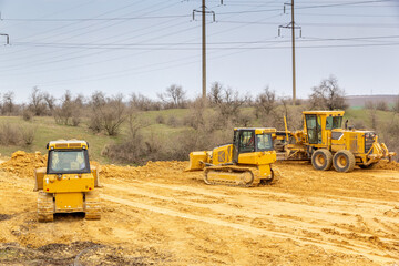 Road construction. Bulldozers level and compact the ground