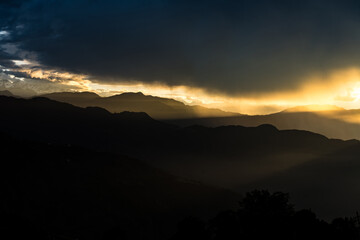 Early morning golden sunrise with clouds in the mountains of Nepal in Kutumsang, Helambu, Nuwakot