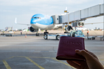 A woman gets on a plane and holds a passport