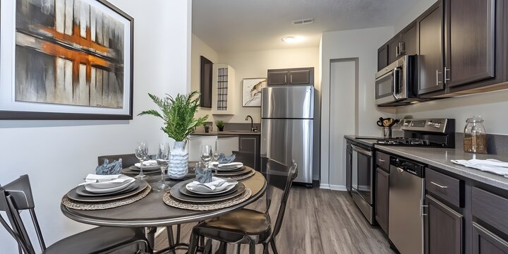 Modern apartment dining area with kitchen.