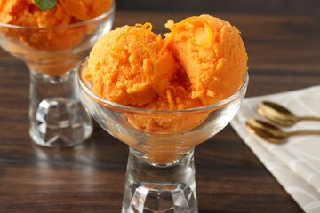 Tasty orange sorbet on wooden table, closeup