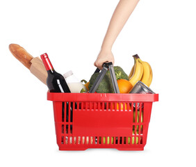 Fototapeta premium Woman with shopping basket full of products on white background, closeup