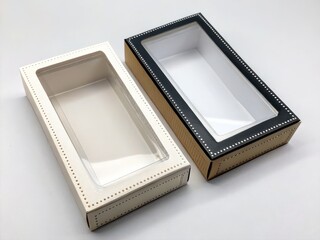 Fototapeta premium Rectangular Packaging Box Mockup. Two empty packaging boxes with transparent lids, one white and one black, displayed on a neutral background.