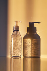 A tube of cosmetic gel or shower gel in the rays of the setting sun.