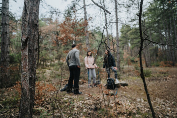 Obraz premium Group of friends spending quality time together in a serene forest setting, embracing nature and friendship.