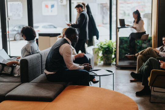A contemporary co working space featuring a variety of people collaborating and working in a comfortable and stylish environment. - Powered by Adobe