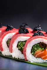 Tuna  Caviar Sushi Roll – A luxurious sushi roll with fresh tuna slices, black caviar, salmon, and vibrant greens, elegantly plated for a gourmet experience.
