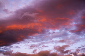 Fiery clouds in the cloudy evening sky