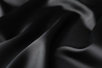 Fototapeta premium Crumpled black silk fabric as background, closeup