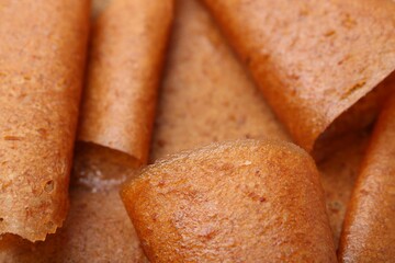 Delicious fruit leather rolls as background, closeup