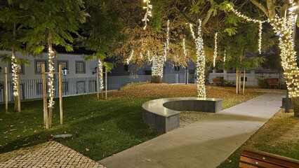 Walkway Through Park Decorated with Holiday Lights – Nighttime Urban Ambience in Portugal