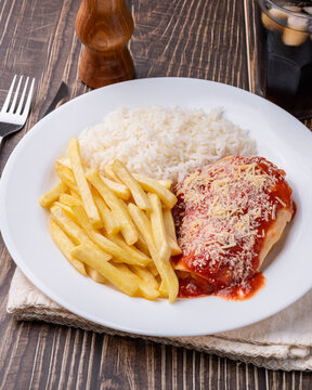 Parmegiana chicken breast, rice and french fries. Typical brazilian executive dish