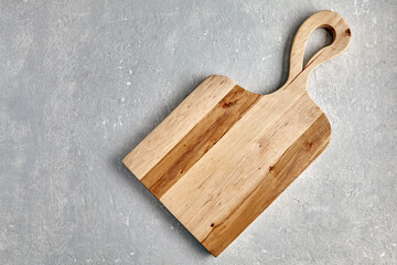Fototapeta premium figured wooden cutting board on grey stone table