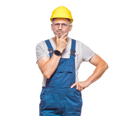 Strict construction worker with hand on chin looking at angry face expression, isolated on white background. Jealous construction worker with doubt expression. Craftsman against white wall