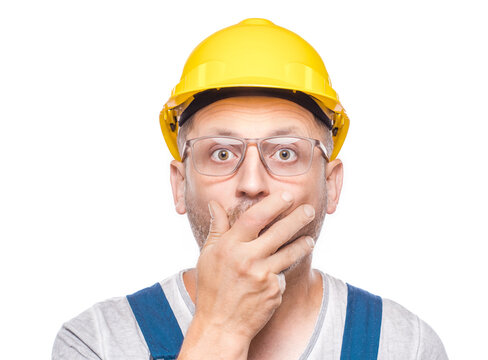 Surprised construction worker stare to camera, isolated on white background. Amazed expression face - head of a amazed repairman. Wao - omg. Craftsman against white wall
