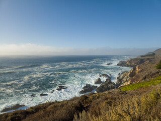 Scenic view of the ocean and sandy beach at Garrapata Beach, California. A natural coastal landscape with waves, cliffs, and unspoiled beauty typical of the Pacific coastline.