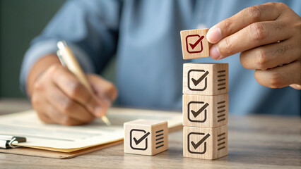 The scene depicts a checklist or assessment being completed with stacked checkmark blocks and simultaneous writing on a document.