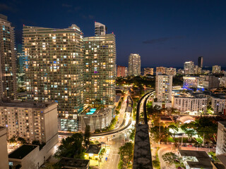 Aerial view of public train tracks running through the modern downtown of Miami, Florida, USA....
