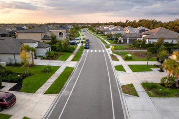 Expensive mansions between green palm trees in southwest Florida suburbs, USA. Aerial view of...