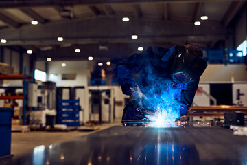 Industrial Worker Performing Welding in a Modern Factory Environment