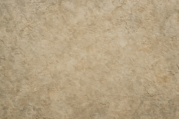 Fototapeta premium A textured beige wall surface, showcasing a warm, natural aesthetic ideal for backgrounds in various projects, including architecture, design, and interior visuals.