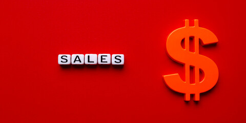 Fototapeta premium Driving Growth SALES spelled with letter blocks alongside a vibrant orange dollar sign on a on transparent background