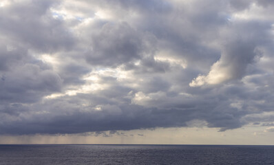 Cloudy Sky Over the Calm Pacific Ocean with Subtle Sunlight Breaks