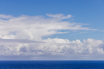 Serene Cloudscape Above the Vast Pacific Ocean Under a Bright Blue Sky