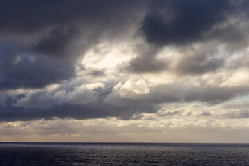 Dramatic Cloudscape Over the Serene Pacific Ocean During Sunset